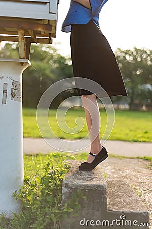 A girl in a black skirt picked up her feet Stock Photo
