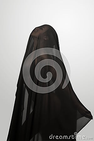 Girl in a black transparent veil on the face. Conceptual portrait in the studio. Stock Photo