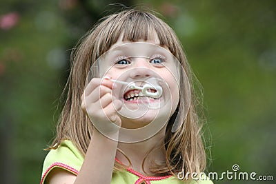 Girl blowing bubbles 4 Stock Photo