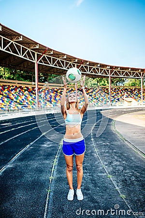 Girl in blue shorts workout on stadium Editorial Stock Photo