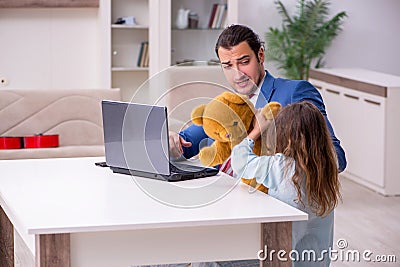 Girl bothering young father during working from house in pandemi Stock Photo