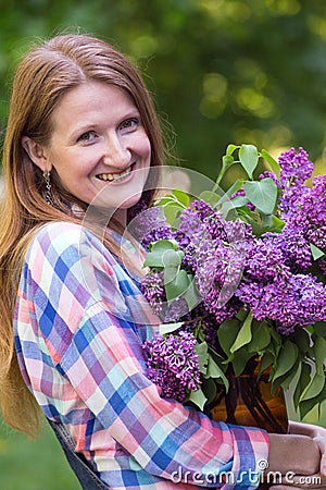 Girl with bouquet of lilacs Stock Photo