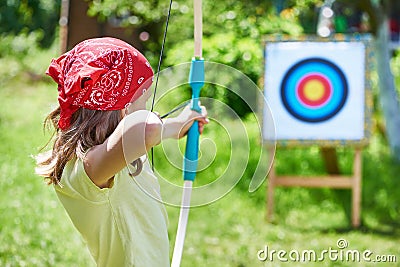 Girl with bow shooting to sport aim Stock Photo