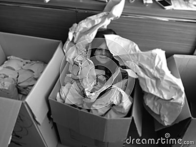 Girl in Box with Paper Stock Photo