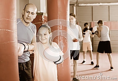 Girl with boxing gloves posing in defended stance Stock Photo