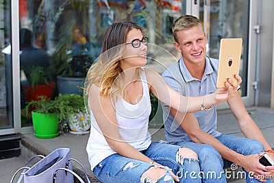 Girl and boy couple sitting on the porch of the restaurant, talk Stock Photo