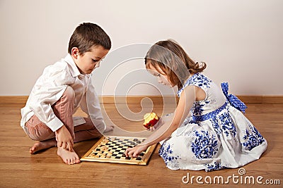 Girl and boy playing chess Stock Photo