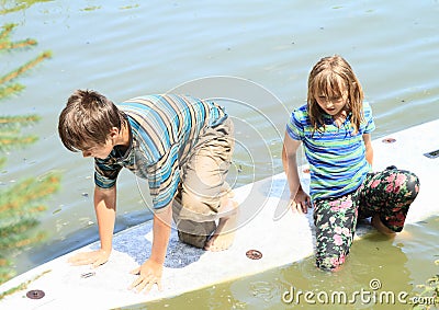 Girl and boy playing on surf Stock Photo
