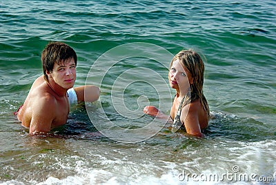 Girl and boy in a sea Stock Photo