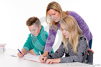 Girl and boy with teache together in the classroom Stock Photo