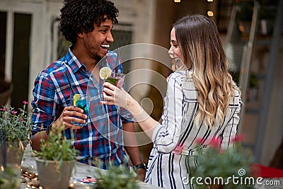 Girl with boy toasting with drink Stock Photo