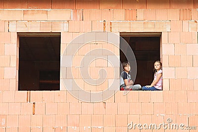 Girl and boy in the window Stock Photo