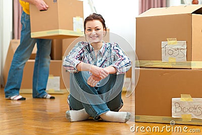 Girl and boyfriend carrying boxes to new house Stock Photo