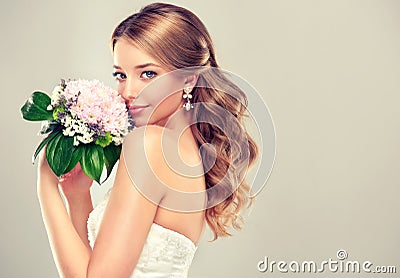 Girl bride in wedding dress with elegant hairstyle. Stock Photo
