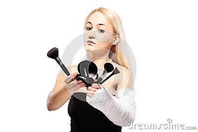 Girl with a broken arm trying to put makeup Stock Photo