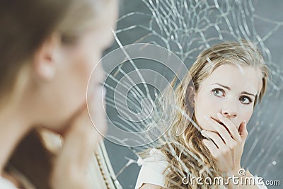 Girl and broken mirror Stock Photo