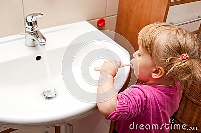 Girl brushing teeth Stock Photo