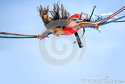 Girl bungee jumping trampoline Stock Photo