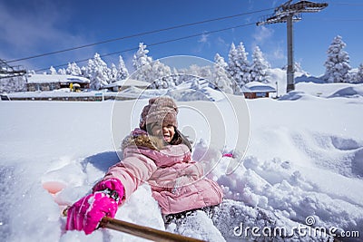 girl burried half of her body while playing outside in the snow Stock Photo