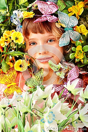 Girl with butterfly and flower on green grass. Stock Photo