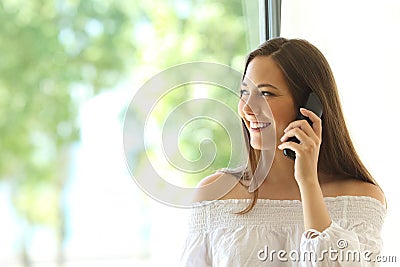 Girl calling on phone landline at home Stock Photo