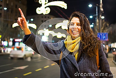 Girl calling taxi in urban environment Stock Photo