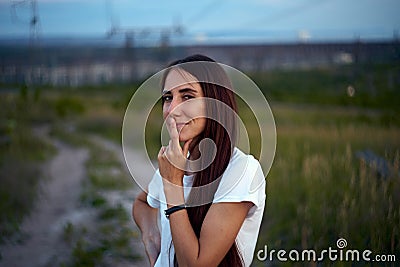 The girl came up with a cunning idea. Sly eyes. finger on lips Stock Photo