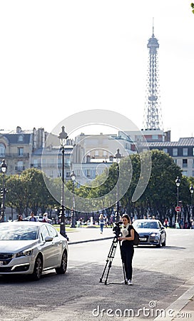 girl cameraman shoots movie camera on paris street Editorial Stock Photo