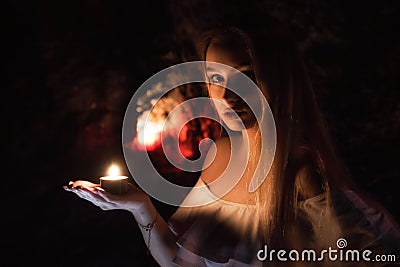 Girl with candle on hand Stock Photo