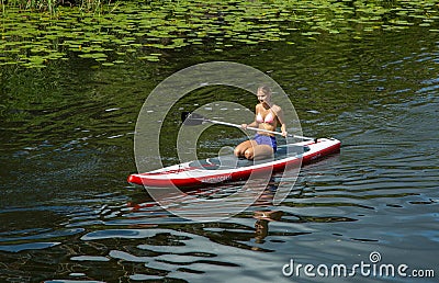 Girl in canoe paddling on a canal in the city Editorial Stock Photo