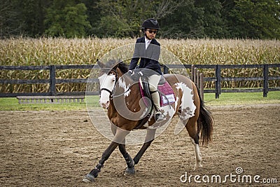 Girl Cantering Paint Pony Stock Photo