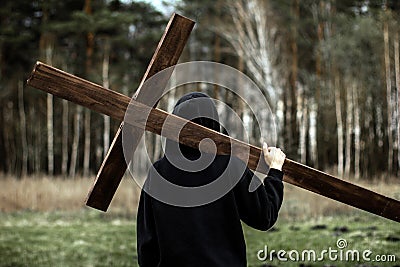 The girl carries the cross. Carry the cross. Man believes in God. Hope in God Stock Photo