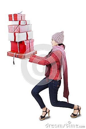 Girl carrying heavy christmas gifts Stock Photo