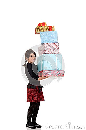 Girl carrying huge pile of christmas presents Stock Photo