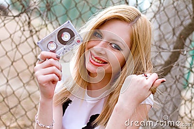 Girl with a cassette in hand Stock Photo