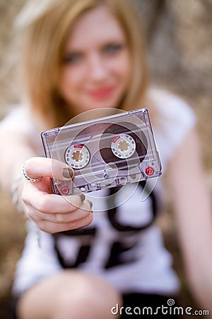 Girl with a cassette in her hand Stock Photo