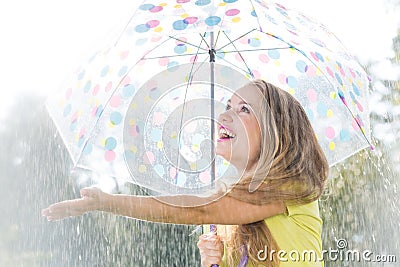 Girl catching raindrops Stock Photo