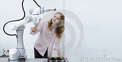 Girl Caucasoid education electronic robotic arm on table at class room. learning innovation robot electronic for future. Stock Photo