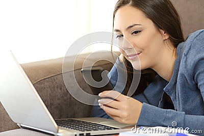 Girl checking smartphone message on a couch Stock Photo