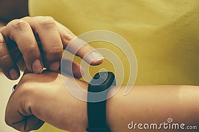 Girl checks pulse on fitness bracelet or activity tracker pedometer on wrist, sport, technology and healthy lifestyle concept Stock Photo