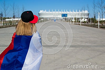 Girl cheerleader heading to the football stadium with the flag of Russia Stock Photo