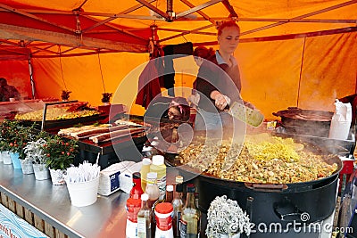 Girl chef cooking in open canteen Editorial Stock Photo