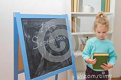 Child at the chalk Board with the inscription on September 1 and Stock Photo