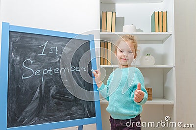 Child at the chalk Board with the inscription on September 1 Stock Photo