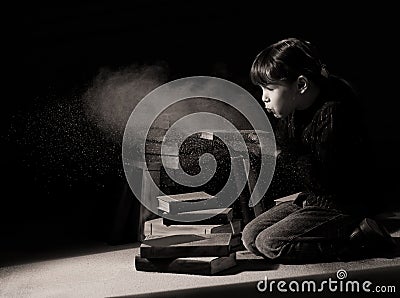 Girl child discovering hidden books in attic Stock Photo