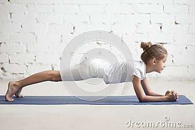 Girl child in Dolphin Plank pose, white studio background Stock Photo