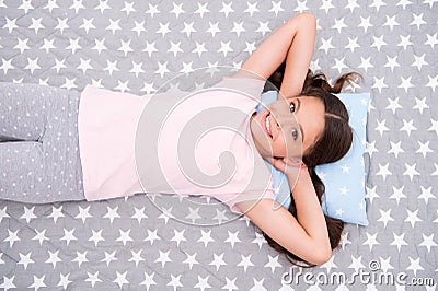 Girl child long hair lay awake top view. Quality of sleep depends on many factors. Girl lay on little pillow full of Stock Photo