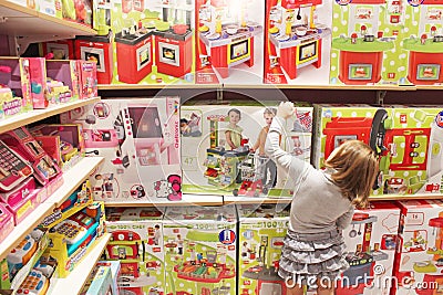 Girl chooses a toy in a toy shop Editorial Stock Photo