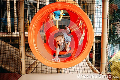Girl climbing the maze in children game center Stock Photo