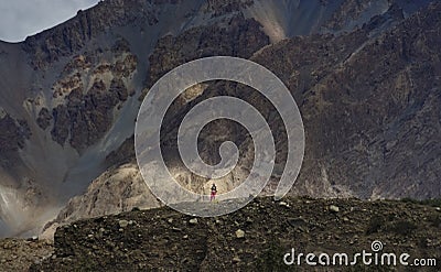 The girl climbing the mountains around the village to notice the return of the men from the mountains Editorial Stock Photo